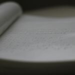 a close up of an open book with writing on it